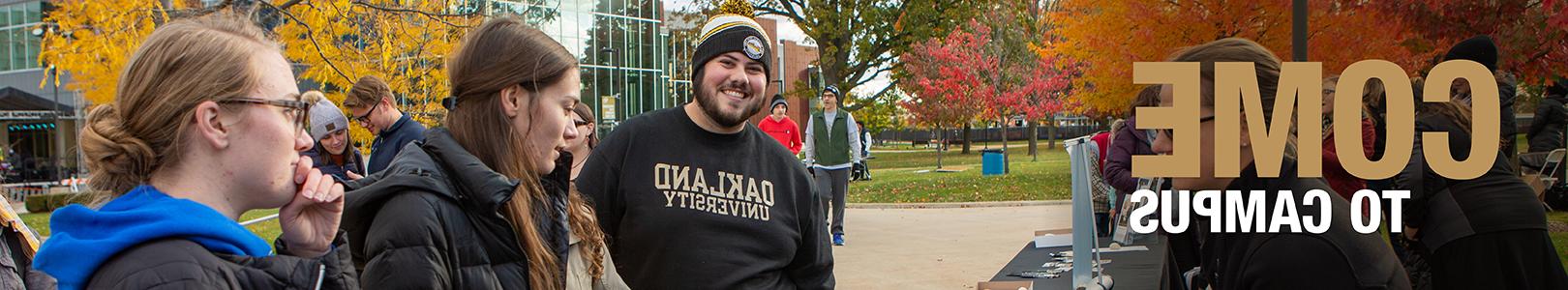 Students wearing "Oakland University" gear outside on campus, with text that reads "Come to Campus" on the left side